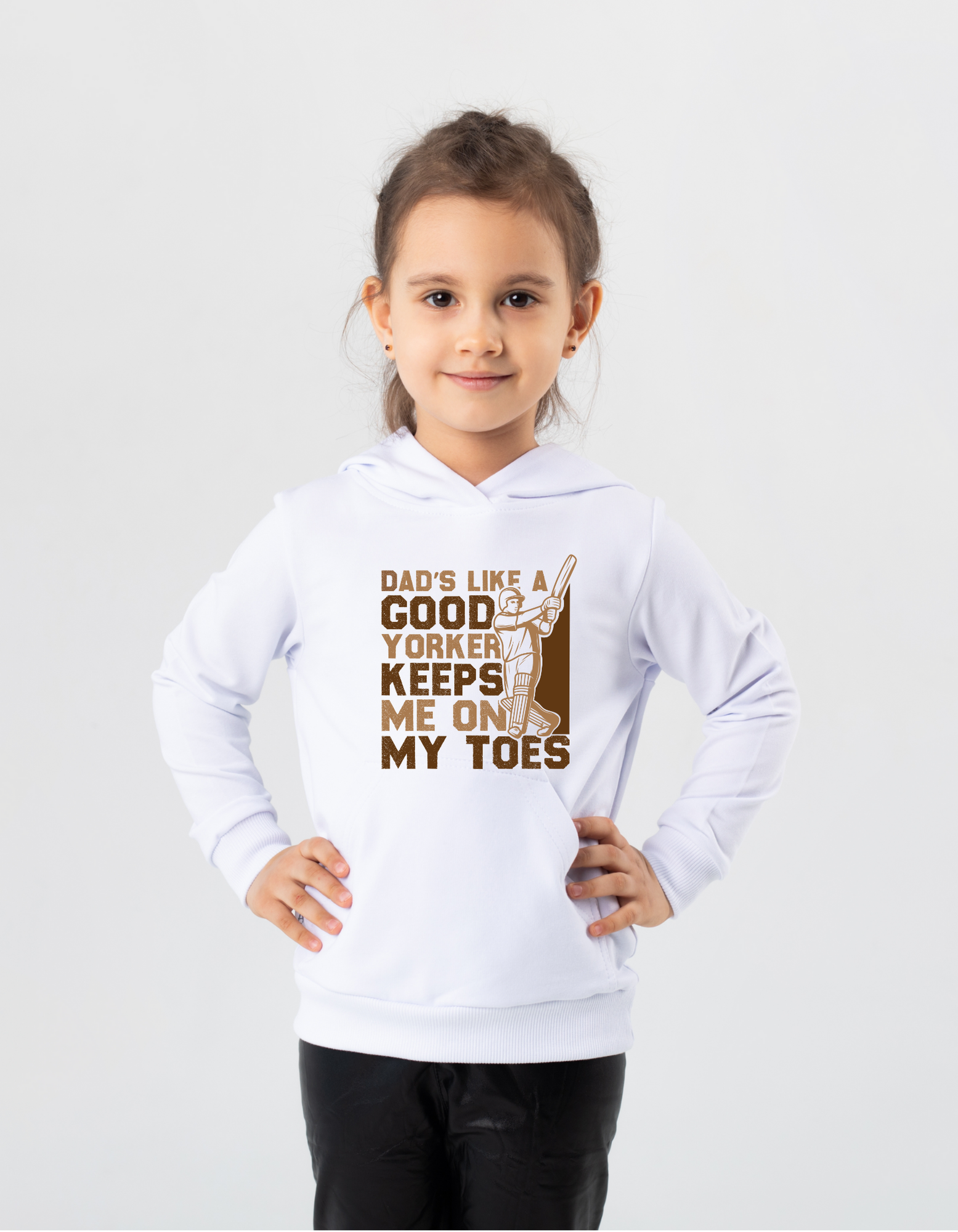 A little girl wearing a white hoodie with Dad’s Like a Good Yorker, Keeps Me on My Toes, on the front!  Funny Cricket Hoodie, Premium Fabric, Multiple Adult Sizes