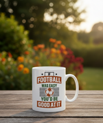 White mug with a humorous football quote on a wooden table outdoors. This is a Cows Corner mug with a funny football slogan 'If Football Was Easy You’d Be Good at It'.  Cows Corner gifts are perfect for sport-mad fans, these gifts work brilliantly for birthdays, new baby celebrations, Father’s Day, Mother’s Day, Christmas, anniversaries, thank you gifts, end-of-season team awards, graduations, retirements, and just-because moments when you want to raise a smile. 
