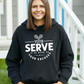A a lady wearing black hoodie with the funny tennis slogan on the front that reads 'I've Seen Better Backhands In A Bar Fight'