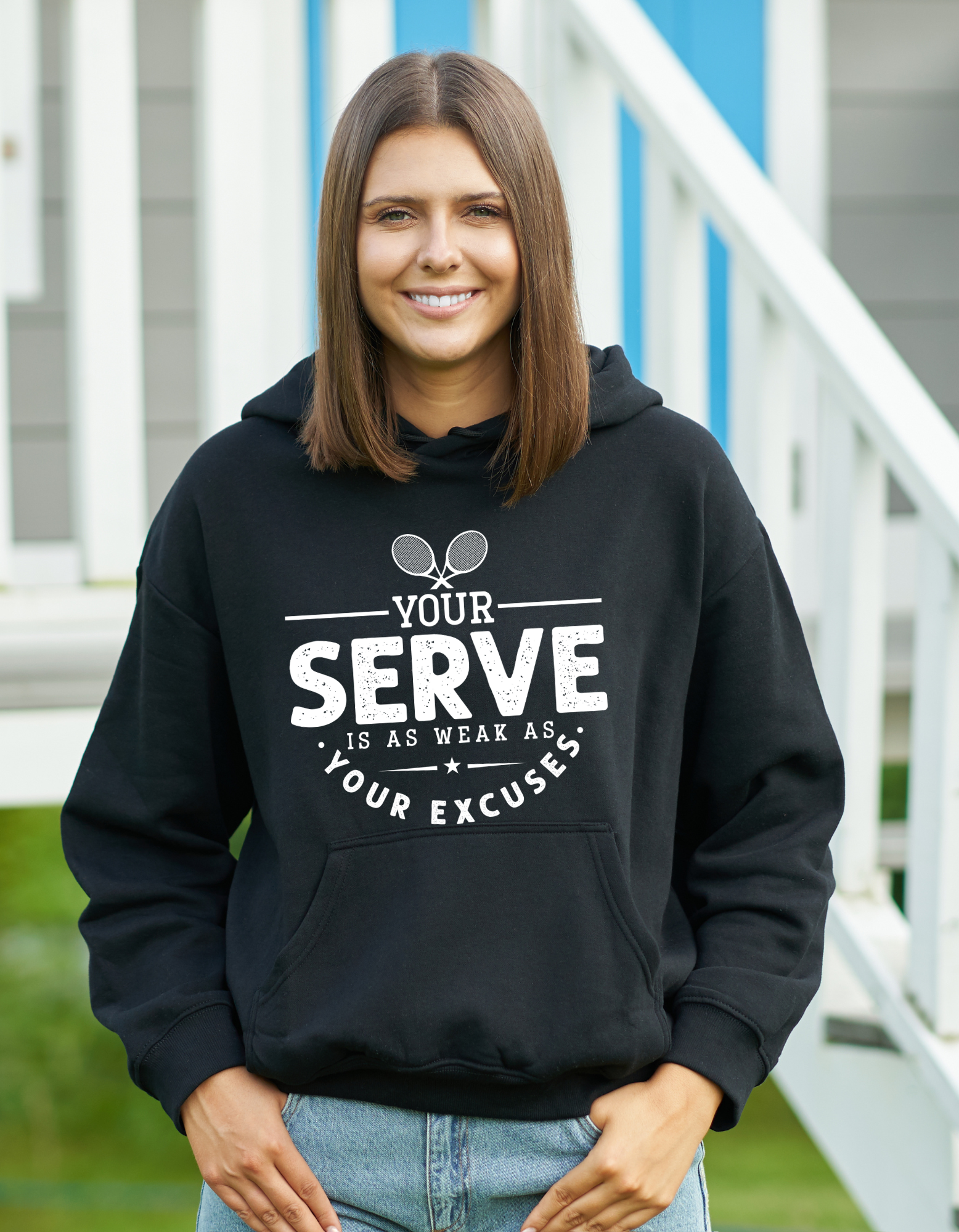 A a lady wearing black hoodie with the funny tennis slogan on the front that reads 'I've Seen Better Backhands In A Bar Fight'