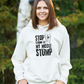 A lady wearing a white hoodie with Stop Looking at My Middle Stump on the front. A Funny Cricket Hoodie, Premium Fabric, Multiple Adult Sizes