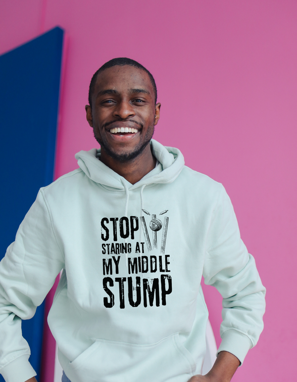A man wearing a white hoodie with Stop Looking at My Middle Stump on the front. A Funny Cricket Hoodie, Premium Fabric, Multiple Adult Sizes
