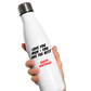 White Cows Corner water bottle with text held by a hand on a white background